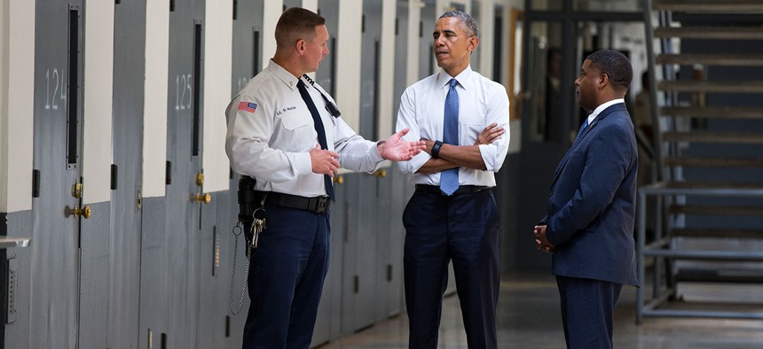  Obama is led on a tour by Bureau of Prisons Director Charles Samuels, right, and correctional officer Ronald Warlick Thursday at Oklahoma's El Reno Federal Correctional Institution.