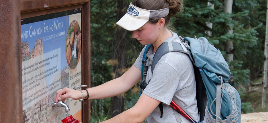 A hiker fills up her bottle at a water station at Grand Canyon National Park in 2013.