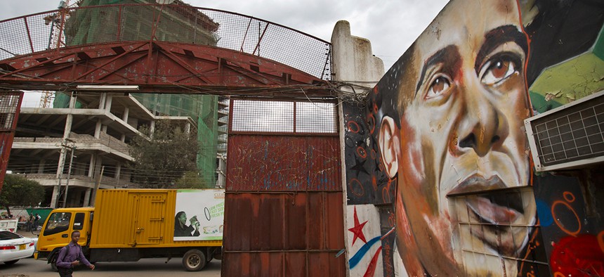 A pedestrian walks past a mural of President Barack Obama at the GoDown Arts Centre in Nairobi. 