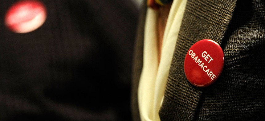 A health care worker in Minnesota wears a button supporting the Affordable Care Act in 2013.