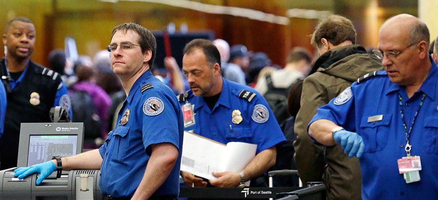 Agents work at  Seattle-Tacoma International Airport in March.