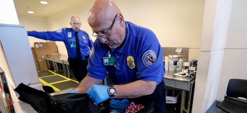 An agent checks a bag at O'Hare international Airport in November.