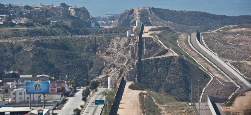 The current fence runs in places along the border, such as this segment near San Diego.
