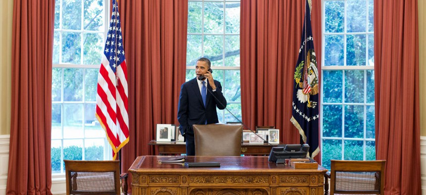 President Obama talks to Solicitor General Donald Verrilli in the Oval Office after learning of the Supreme Court's ruling on the Patient Protection and Affordable Care Act, June 28, 2012.