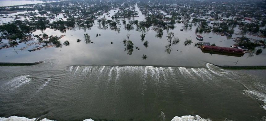 Floodwaters pour through a levee near downtown New Orleans on Aug. 30, 2005.