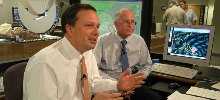 FEMA Director Michael Brown, left, discusses preparation efforts for Hurricane Frances Sept. 1, 2004, at the National Hurricane Center in Miami with NHC director Max Mayfield. 
