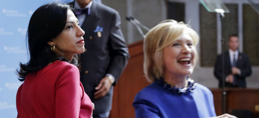Huma Abedin, left, an aide to Hillary Clinton, watches Clinton greet members of the audience following a speech at the David N. Dinkins Leadership and Public Policy Forum New York last spring. 