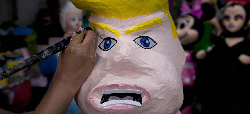 Alicia Lopez Fernandez paints a piñata in the likeness of Donald Trump at her family's store "Piñatas Mena Banbolinos" in Mexico City in July.
