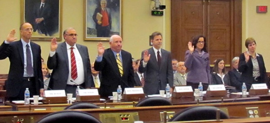 Recovery board members are sworn in to testify at a congressional hearing on accountability and transparency efforts in 2011.