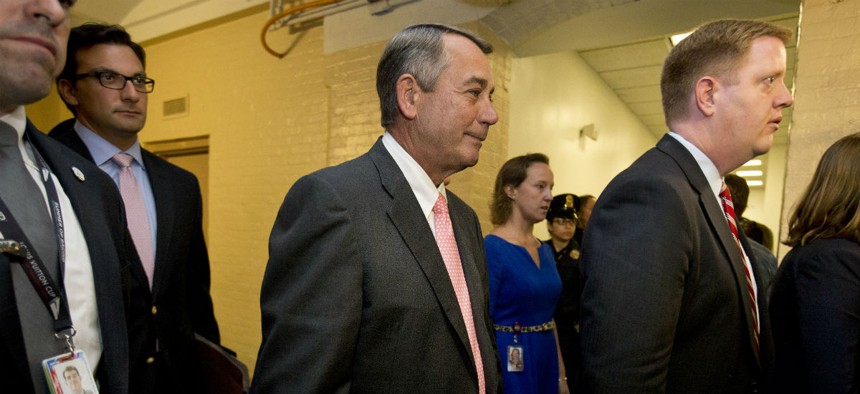 House Speaker John Boehner leaves a meeting with the House GOP on Friday. In a stunning move, Boehner informed fellow Republicans he would resign from Congress at the end of October.