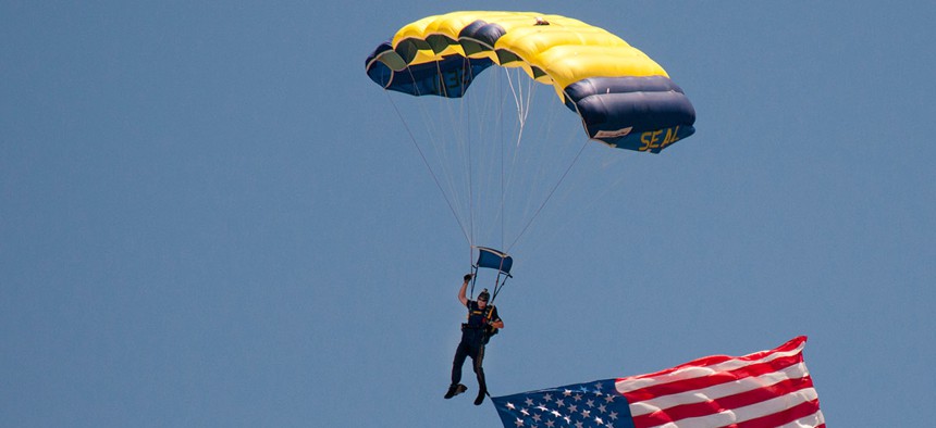 A member of the Navy parachute demonstration team jumps during the capabilities portion of the SEAL West Coast Reunion in 2012.