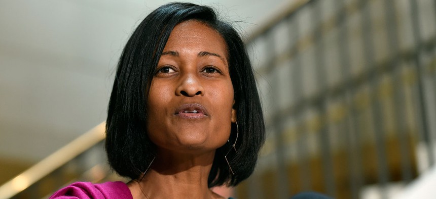 Former Hillary Clinton aide Cheryl Mills speaks to reporters on Capitol Hill in September.