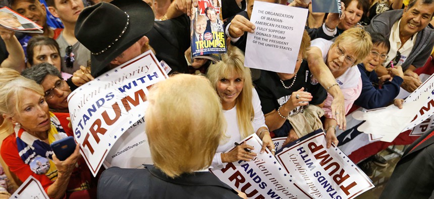 Donald Trump signs autographs for a group of supporters after a rally in Richmond, Va., on Wednesday.