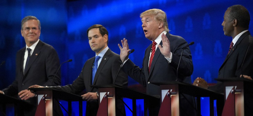 Republican presidential contenders (from left) Jeb Bush, Marco Rubio and Ben Carson look on as Donald Trump answers a question during the debate. 