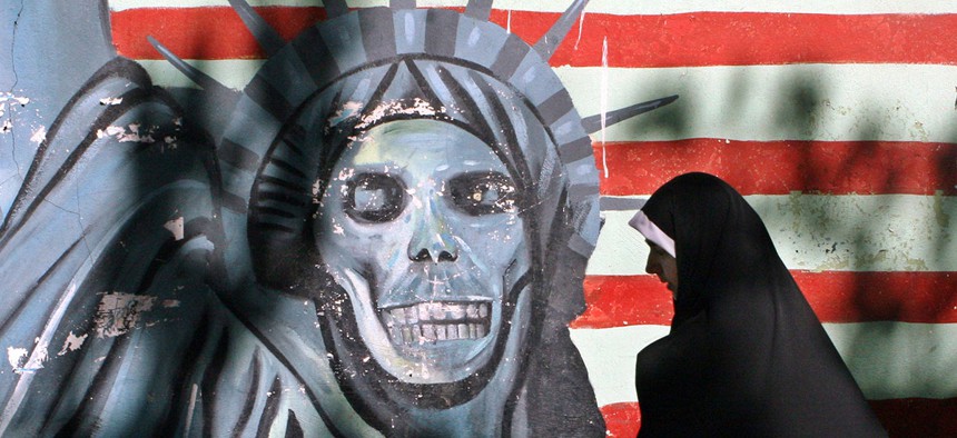 A woman walks past anti-U.S. graffiti in Iran in 2007.