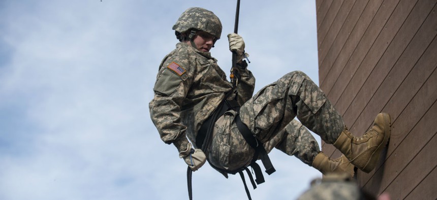 A U.S. Army Reserve military police soldier rappels down a 40-foot tower during training at Camp Atterbury, Ind.