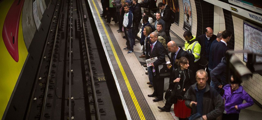 London travelers wait for a train at Waterloo Underground Station in 2014.