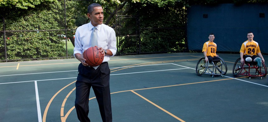  Barack Obama prepares to take a shot before watching a game played by members of the National Naval Medical Center's Marine Wounded Warrior basketball team on the White House basketball court in 2009.