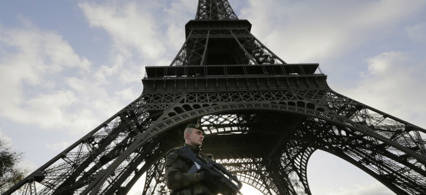 A French soldier stands guard at the Eiffel Tower, which was closed Sunday.  