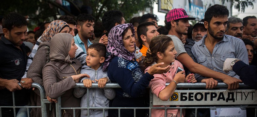 Syrian refugees wait to be registered by police in the southern Serbian town of Presevo in September.