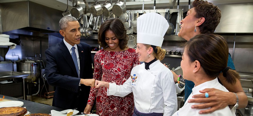 Barack Obama fist bumps Executive Pastry Chef Susie Morrison after sampling pies with First Lady Michelle Obama, ABC News Anchor Robin Roberts and Executive Chef Cris Comerford during an interview about Thanksgiving in the White House Kitchen in 2014.
