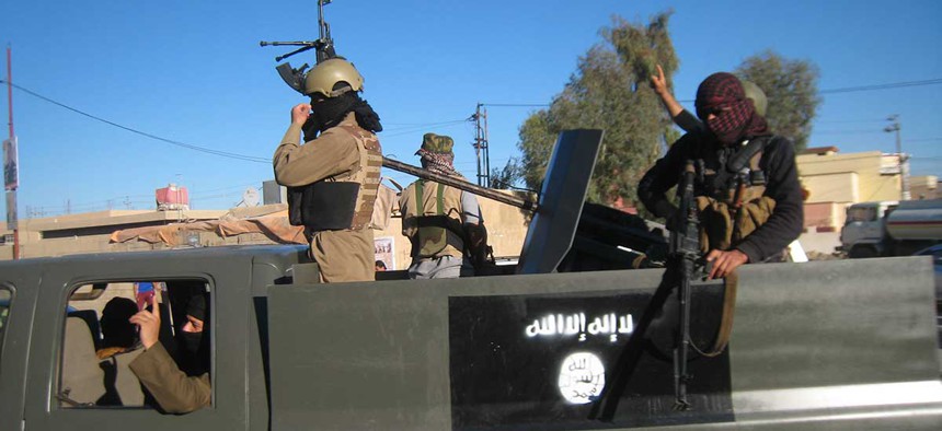 Islamic State militants patrol an Iraqi city in 2014.