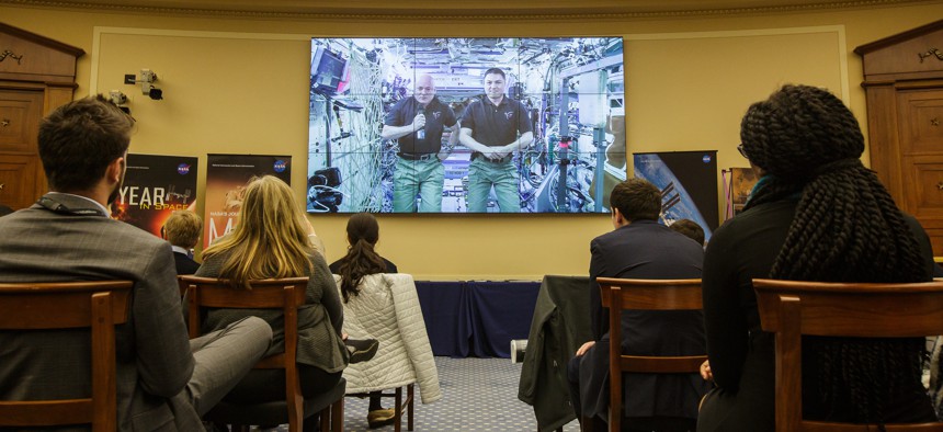 NASA astronauts Scott Kelly, Expedition 46 Commander, left, and Kjell Lindgren, Expedition 46 Flight Engineer, right, are seen from onboard the International Space Station during a House Committee on Science, Space and Technology hearing Wednesday.