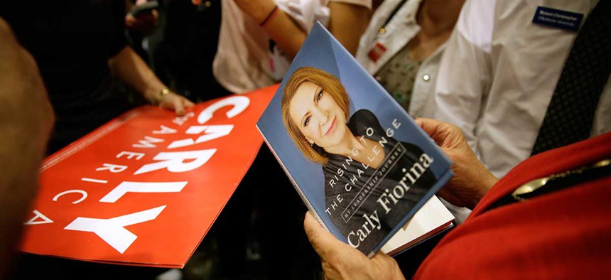An audience member holds a book as she waits to get it signed by Republican presidential candidate Carly Fiorina in September in Iowa.