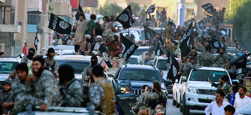Islamic State militants parade in Syria in 2014.