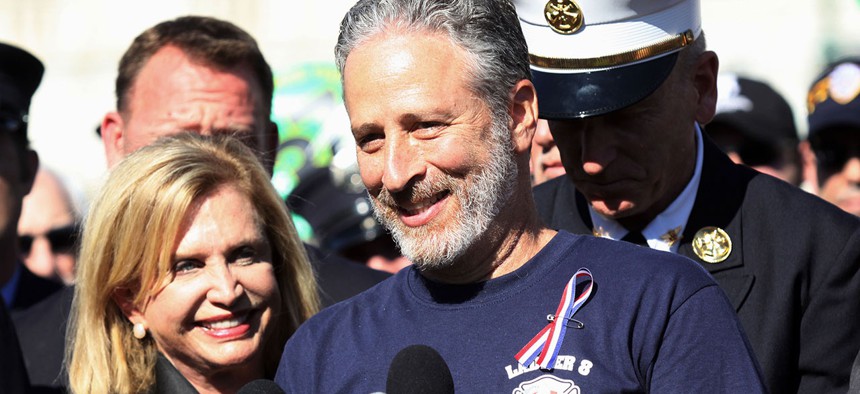 Jon Stewart, accompanied by Rep. Carolyn Maloney, D-N,Y., and New York City first responders speaks during a rally on Capitol Hill in September.