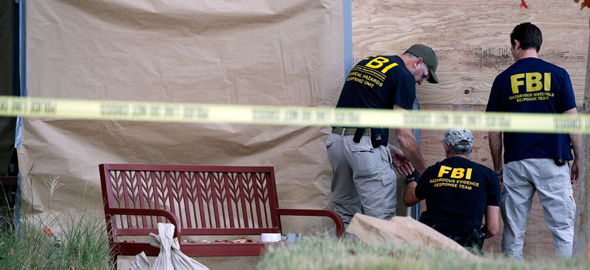 Investigators work the site of a mass shooting at the Inland Regional Center on Dec. 7 in San Bernardino.