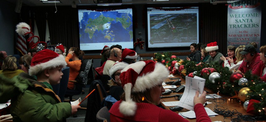 Volunteers help answer phone calls and letters to Santa in 2009 at NORAD.