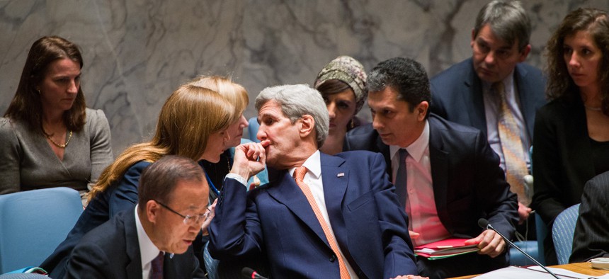 Secretary of State John Kerry speaks with the U.S. Ambassador to the UN, Samantha Power, during the UN Security Council meeting on Syria on Dec. 18.