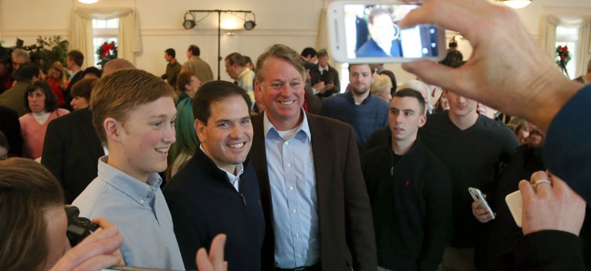 Republican presidential candidate Sen. Marco Rubio, R-Fla., poses for photos during a campaign stop Monday in Rochester, N.H. 