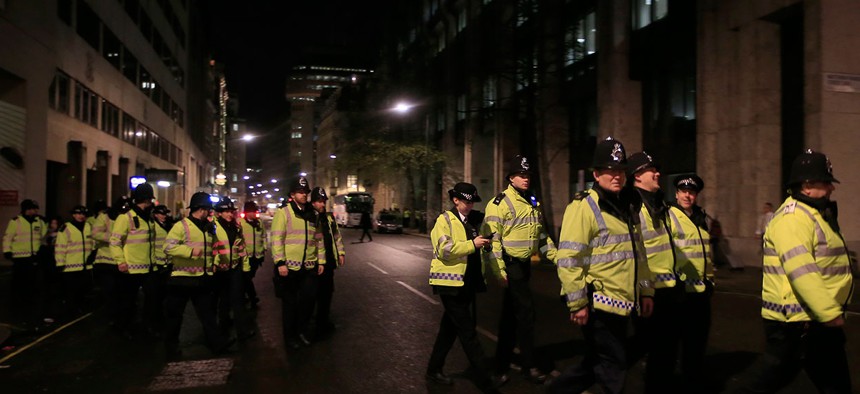 Police officers deploy to their positions ahead of New Years Eve celebrations in London Thursday.