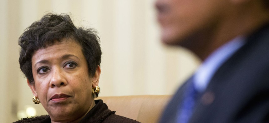 Attorney General Loretta Lynch listens as Obama speaks about actions to curb gun violence. 