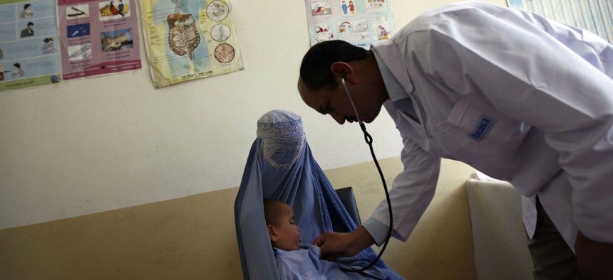 A doctor examines a child at a health clinic in Kabul, Afghanistan.