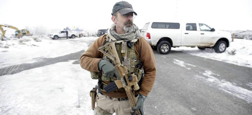 A man stands guard at the Malheur National Wildlife Refuge.