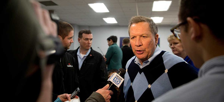 John Kasich speaks to reporters after a town hall meeting in Davenport, Iowa.