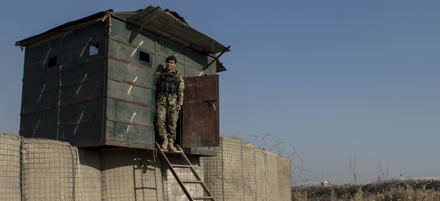 An Afghan airman stands at his security post near Forward Operating Base Oqab in Kabul, Afghanistan.