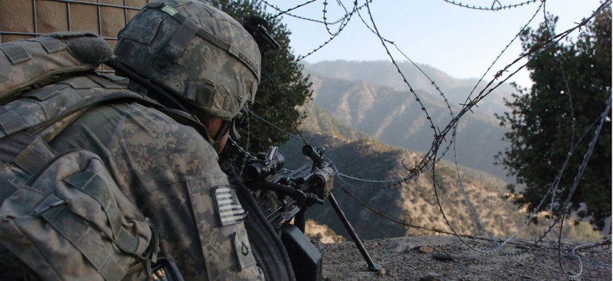 An Army soldier with Company B, 2nd Battalion, 12th Infantry Regiment, 4th Infantry Division, scans the Korengal Valley in Afghanistan.