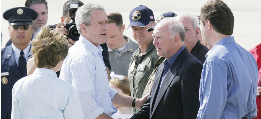 President George W. Bush greets the mayors of Biloxi and Gulfport, Miss., in March 2006, months after Hurricane Katrina devastated the Gulf Coast. 