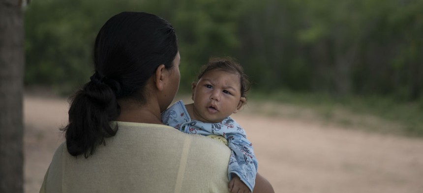 Josiane da Silva holds her son Jose Elton, who was born with microcephaly, outside her house in Alcantil, Paraiba state, Brazil. Zika is thought to cause birth defects. 