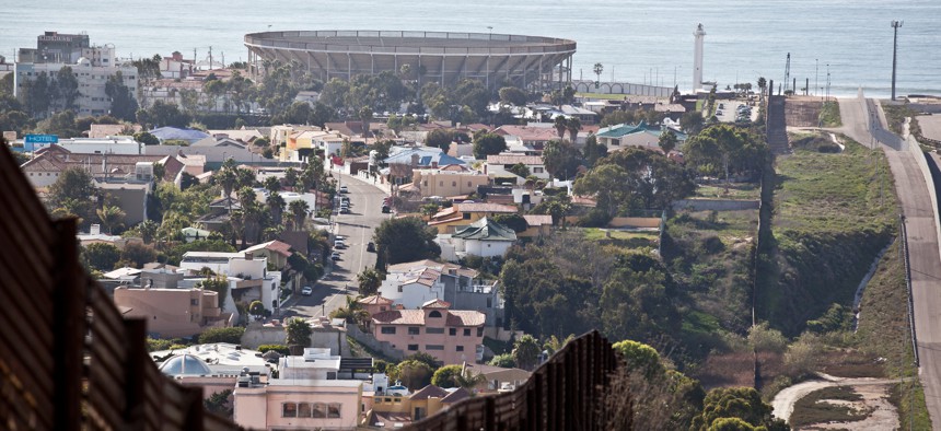 The current border fence is shown in 2012 with Tijuana on the left and California on the right.
