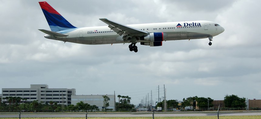 A flight lands at Miami International Airport.