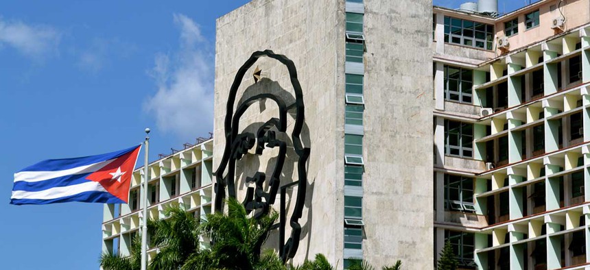 A Cuban flag flies near Che Guevara mural adjacent to Jose Martí plaza in Havana.