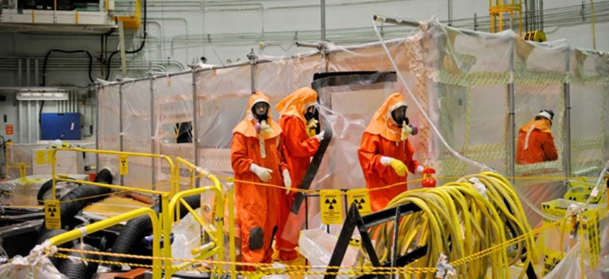 Employees work on the Experimental Breeder Reactor-II facility in Idaho.