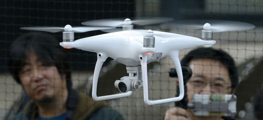 Employees of DJI, a major Chinese consumer-drone maker, demonstrate their latest model Phantom 4 in Tokyo on March 3.
