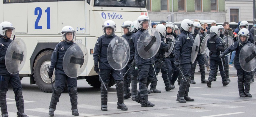 Riot police secure a zone in the Molenbeek neighborhood in Brussels, Belgium. 