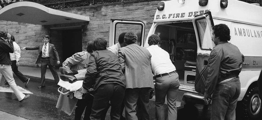 Secret Service Agent Timothy J. McCarthy is loaded into an ambulance after being wounded during an assassination attempt on Ronald Reagan in 1981